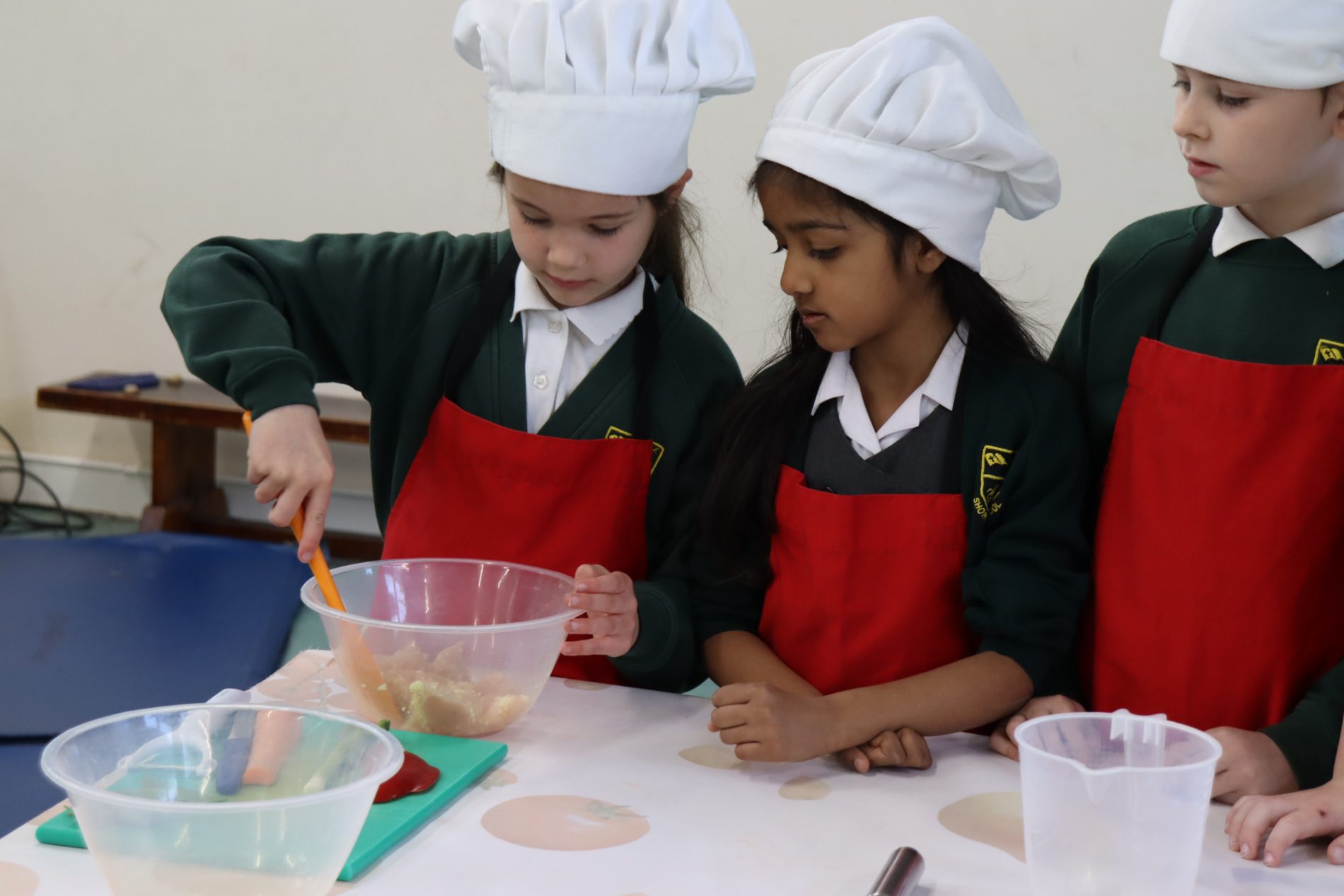 Group 6 pupils learning cooking in DT lessons with Roots to Food