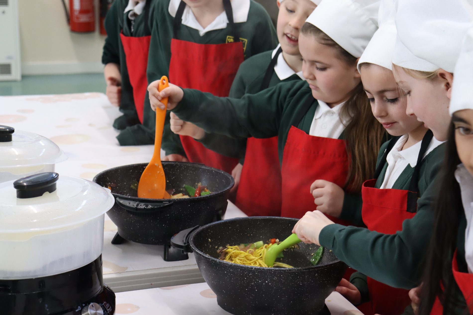 pupils learning to cook with Roots to Food in DT lessons