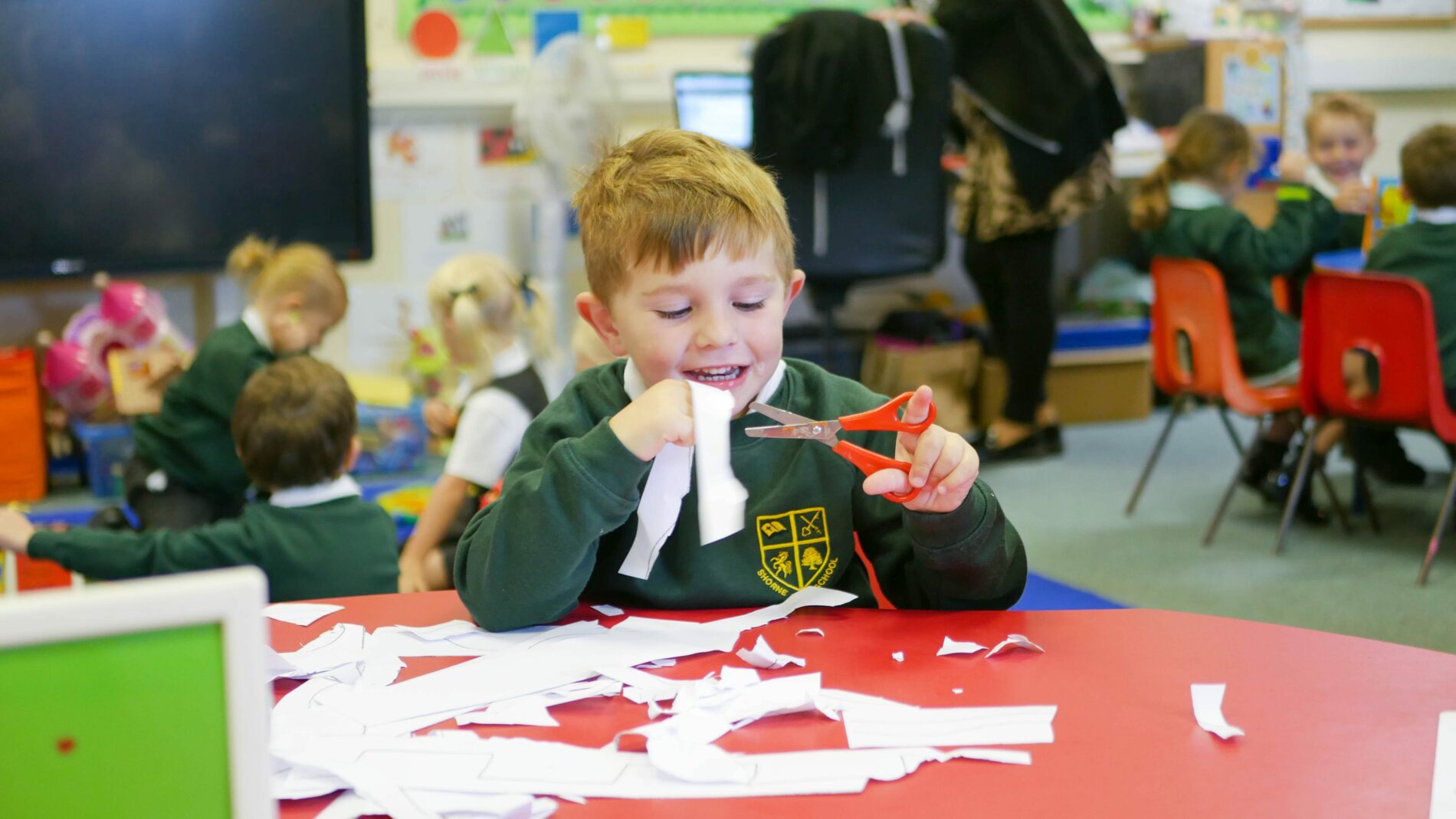 P1170820 pupil in EYFS cutting and sticking in DT lesson