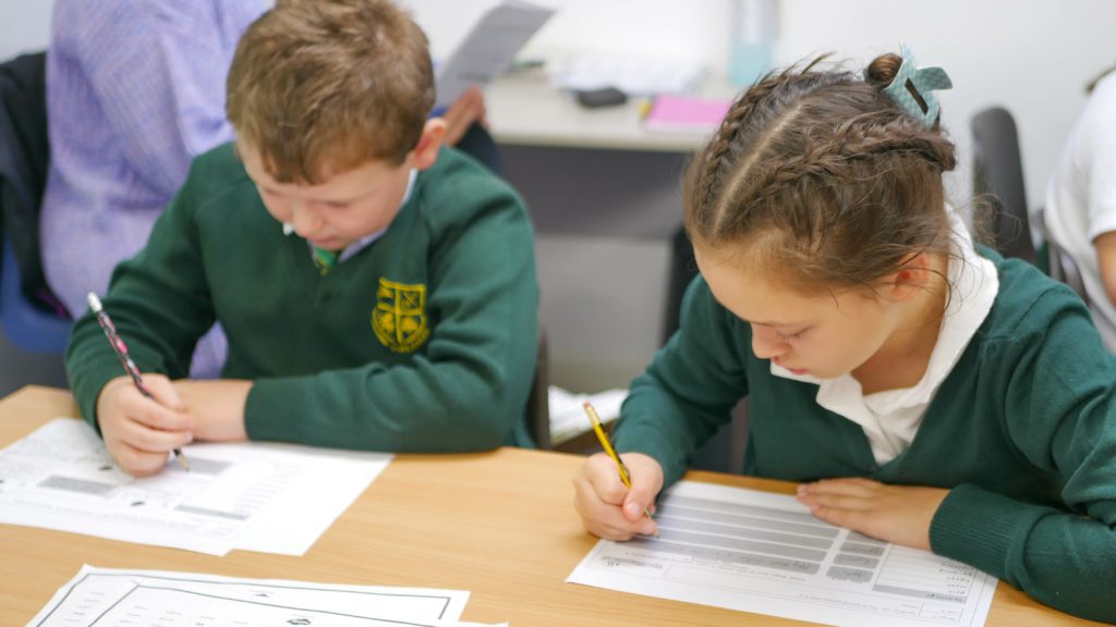 P1170860 pupils writing together during an english class at shorne cofe primary school