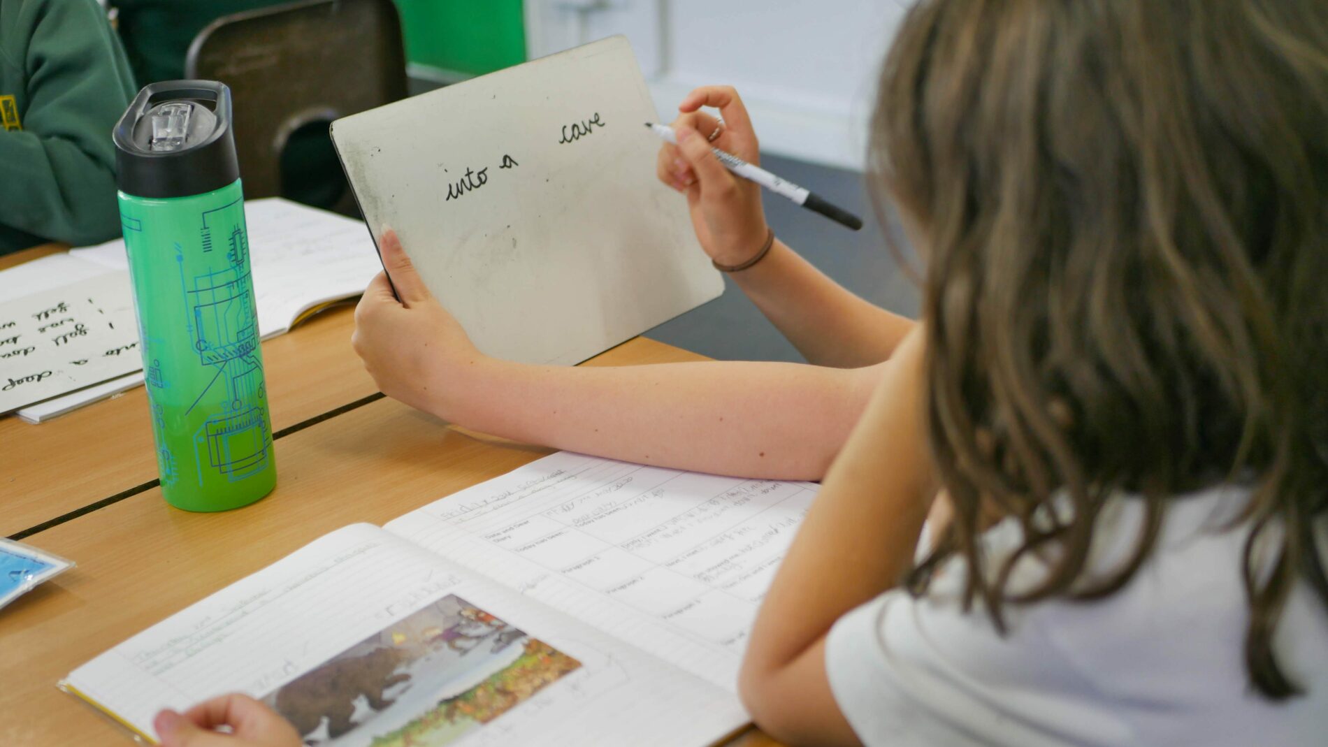 P1170971 teacher helping a student with handwriting at shorne cofe primary school