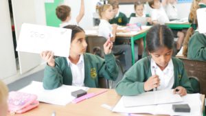 pupils holding up whiteboards in class at shorne cofe primary school