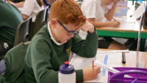 ks2 pupil concentrating with a maths mock exam at shorne cofe primary school