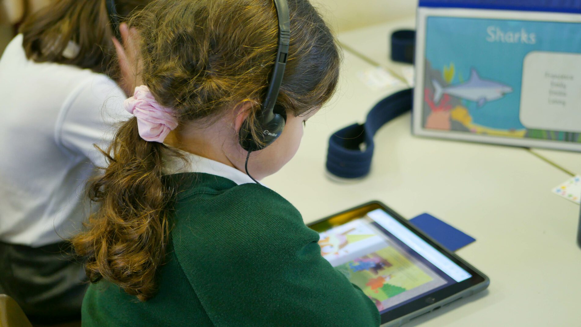 P1180197 pupil using ipad in computing lesson to watch how to videos at shorne primary school