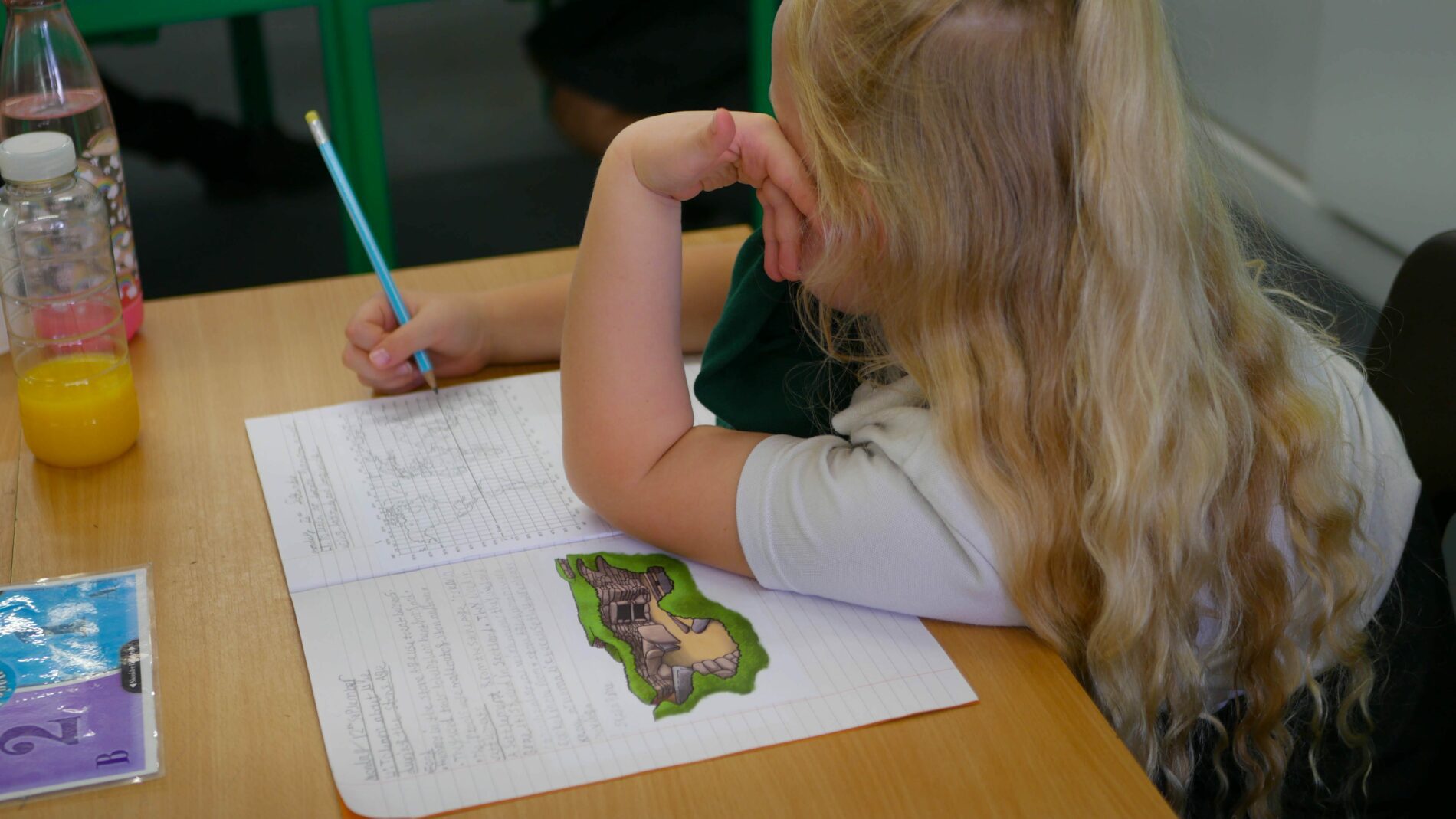 P1180227 child learning about maps in georgraphy lesson