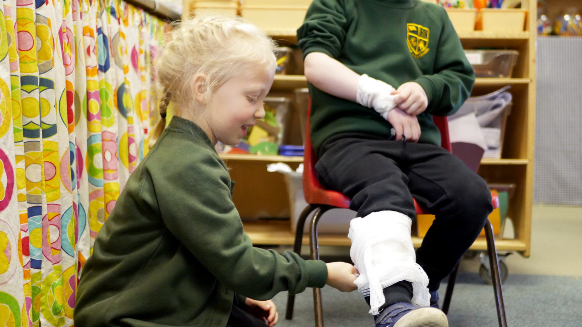 EYFS pupil in Science learning how to bandage and basic first aid