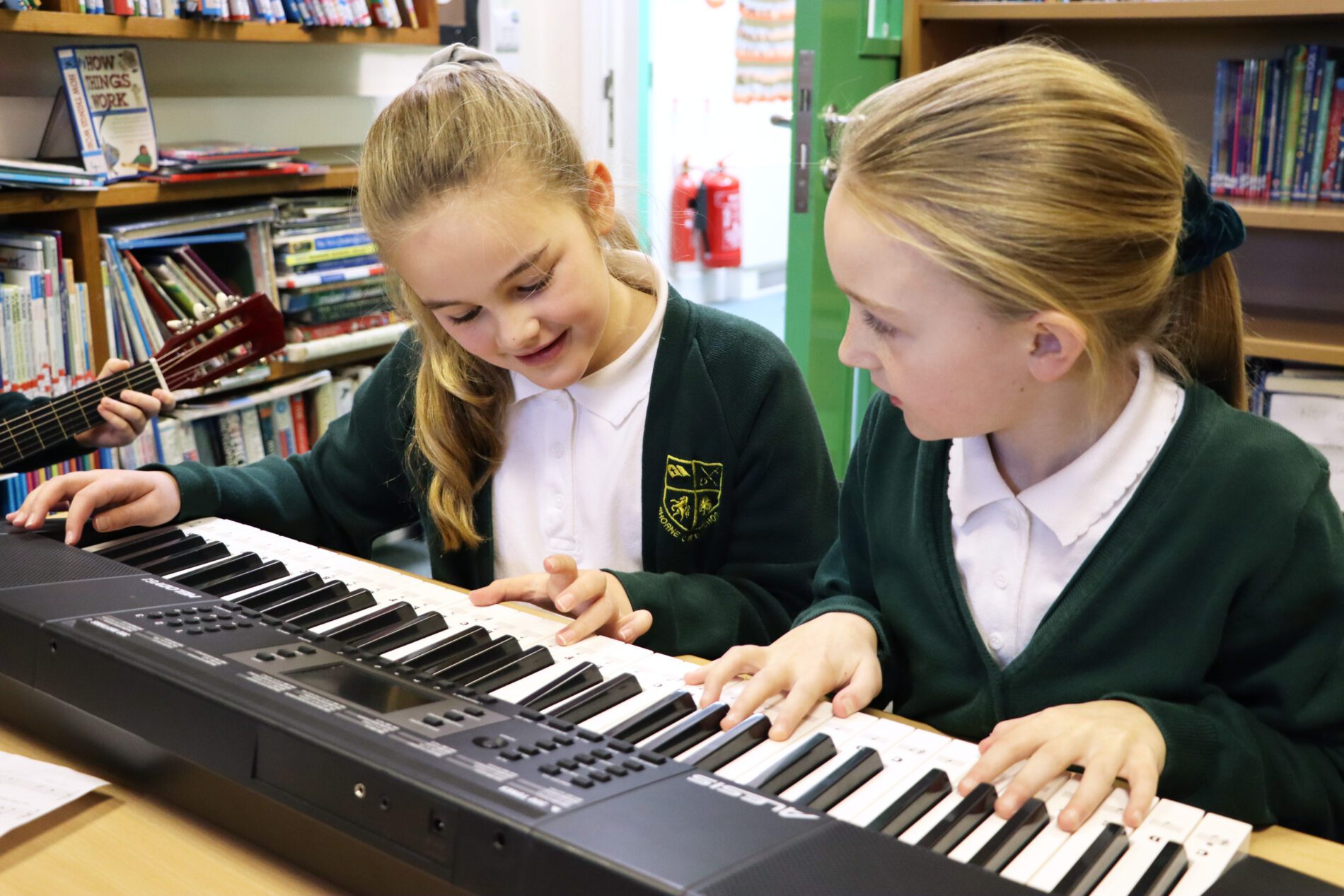 pupils working together to make music on keyboard in shorne primary school