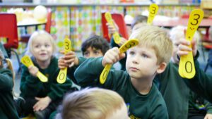 P1190380-2 EYFS children showing numbers in maths at shorne primray school